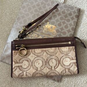 Coach Optic Swirl logo wallet with a detachable wrist strap